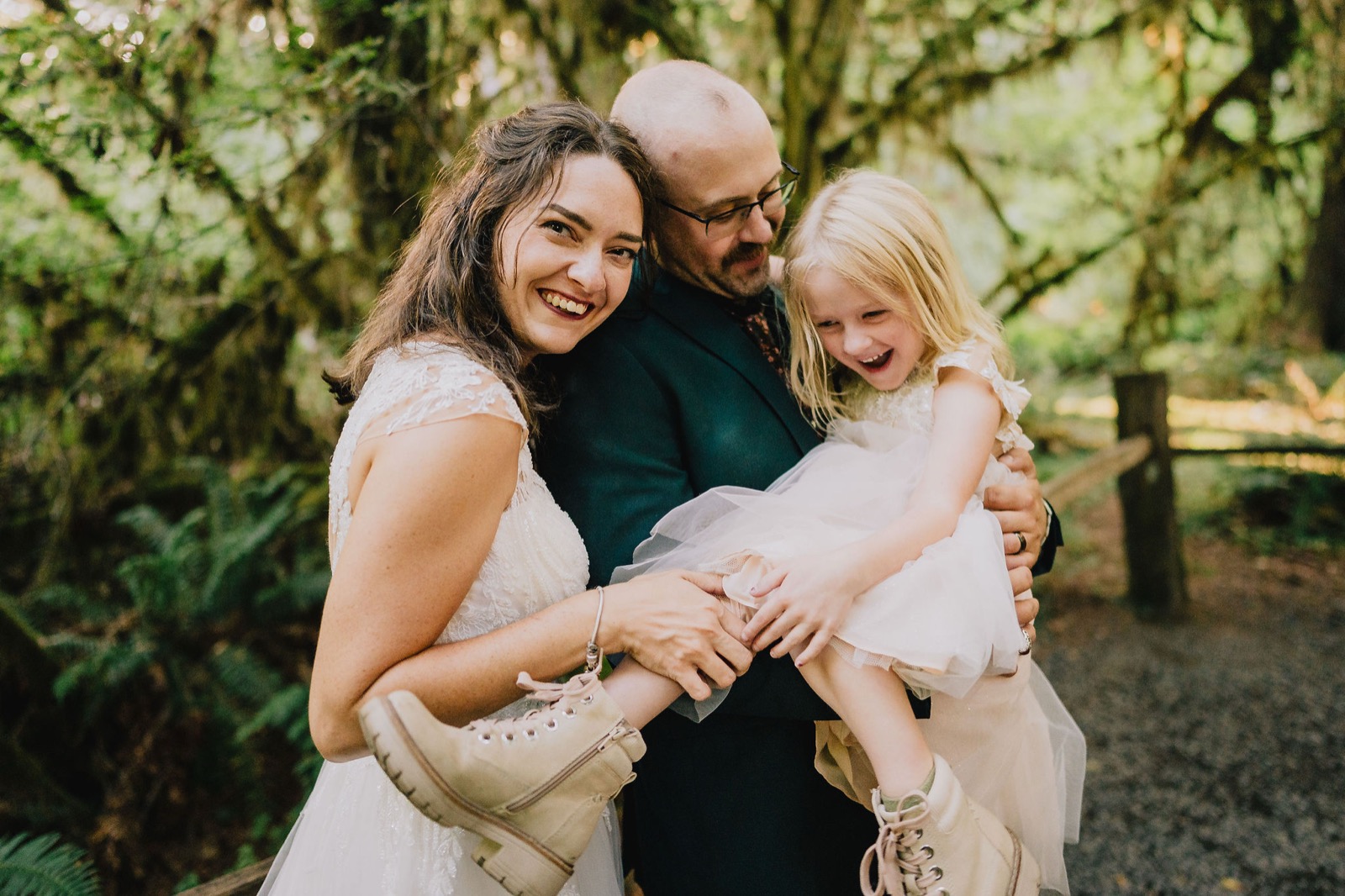 Adriana and Mitchell with their daughter among the moss covered trees of the Hoh Rainforest